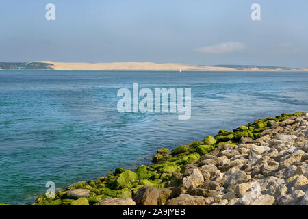 Küste mit einem Ufer Schutz von Stein am Cap gemacht - mit der Düne von Pilat im Hintergrund Frettchen. Gemeinde im Département in Frankreich Stockfoto