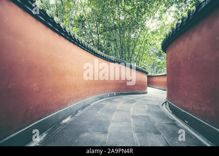 Geheimnisvolle rote Wände Passage von Bambus Wald umgeben, Farbe Tonen angewendet, Chengdu, China. Stockfoto