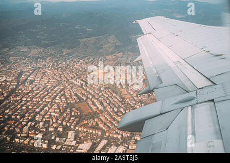 Izmir, Türkei. Schöne Stadtbild von türkischen Stadt Blick aus dem Flugzeug Fenster. Weiße Wohnhäuser am Hang. Immobilien Vorort im Sommer Tag. Stockfoto