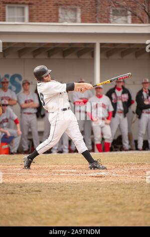 In voller Länge Profil geschossen, von der Johns Hopkins University Herren Baseball Team Player, schwingen die Fledermaus während eines Spiels mit der Rutgers Universität, 7. März 2009. Vom Homewood Sammlung Fotografie. () Stockfoto