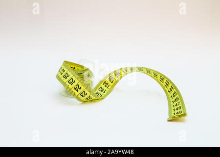 Gelbe Maßband in Meter und Zoll in einer Spirale Stockfoto