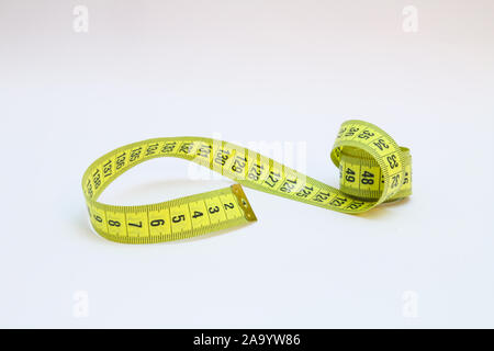 Gelbe Maßband in Meter und Zoll in einer Spirale Stockfoto