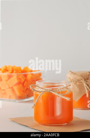 Hausgemachte Kürbis Marmelade in die Gläser auf dem Tisch. Herbst Rezepte, Gerichte aus einem Kürbis. Erhaltung. In vertikaler Ausrichtung Hintergrund. Stockfoto