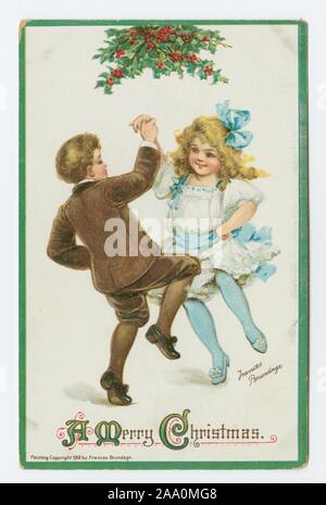 Illustrierte Postkarte 'Frohe Weihnachten' mit einem Jungen und einem Mädchen tanzen unter Holly Zweige, die von der Künstlerin Frances Brundage, 1920. Von der New York Public Library. () Stockfoto