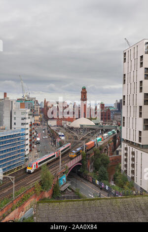 Transport für Wales Class 175 Zug passiert ein GBRF Güterzug, die Container an der Manchester Oxford Road auf der überlasteten Linie Castlefield Stockfoto