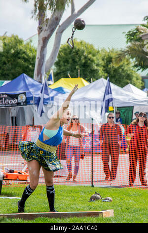 Kristin Rhodes, drei Mal mit dem 'World's stärkste Frau", wirft in der Gewichtung für die Entfernung der Wettbewerb auf einem Schottischen Pride Festival in Costa Mesa, CA. Hinweis clan Zelte im Hintergrund. Stockfoto