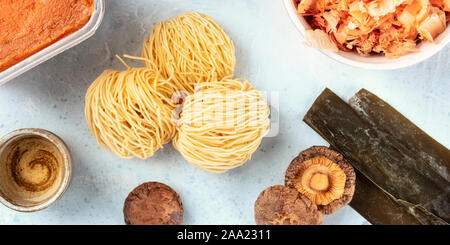 Ramen Zutaten Panorama. Getrocknete meer Gemüse Kelp, Soba-Nudeln, dashi, Thunfisch Flocken, Shiitake-Pilze, Sake, Rotes Miso einfügen, Schuß von der Oberseite Stockfoto