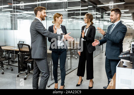 Geschäft Leute streng gekleidet in den Anzügen treffen im Flur des modernen Büro Stockfoto