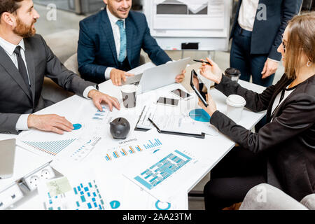 Geschäft Leute während einer Konferenz im Tagungsraum, Aussicht auf den Tisch mit finanziellen Pläne und Gadgets Stockfoto