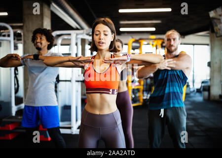 Fitness, Sport, Training und Lifestyle Konzept. Gruppe von Menschen, die das Trainieren im Fitnessstudio Stockfoto