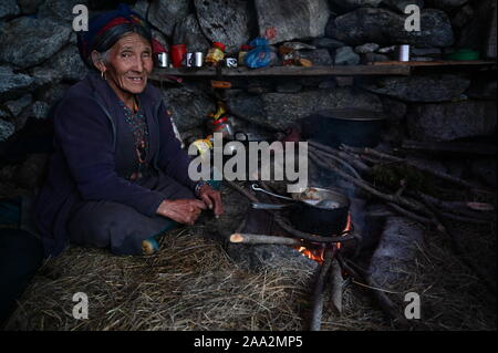 Ein herder aus dem Kyanjin Kharka von langtang Tal bereitet yak Milch Tee in Ihre temporäre Stone Home. Stockfoto