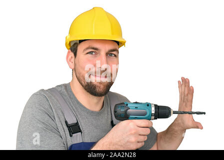Freundliche Bauarbeiter - Handwerker in Arbeitskleidung mit einer Bohrmaschine auf weißem Hintergrund isoliert Stockfoto