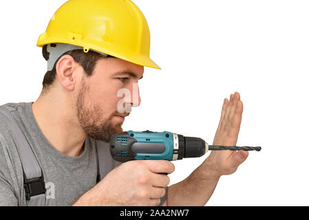 Freundliche Bauarbeiter - Handwerker in Arbeitskleidung mit einer Bohrmaschine auf weißem Hintergrund isoliert Stockfoto