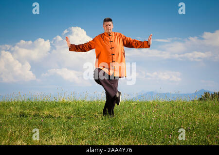 Ein Mann, der unter freiem Himmel Qi-Gong-Uebungen durchfuehrt Stockfoto