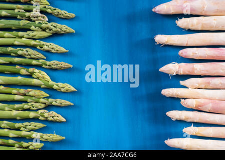 Frischer grüner Spargel schießt Muster, auf blauem Hintergrund Holz Stockfoto