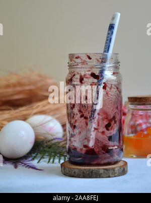 Leere strawberry jam Jar mit Löffel. Weiße Eier und wenig orange Jam jar. Stockfoto