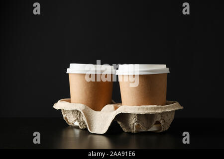 Umweltfreundliche Kaffeetassen auf schwarzem Hintergrund, Platz für Text Stockfoto