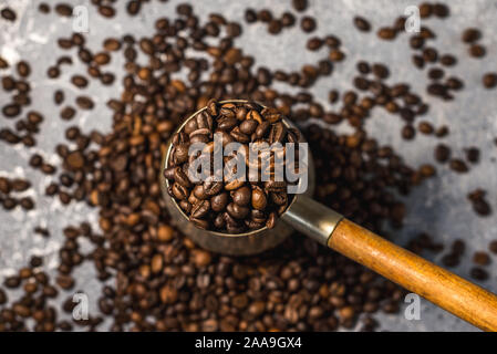 Kaffeemaschine und Kaffee Bohnen auf grauem Hintergrund Stockfoto