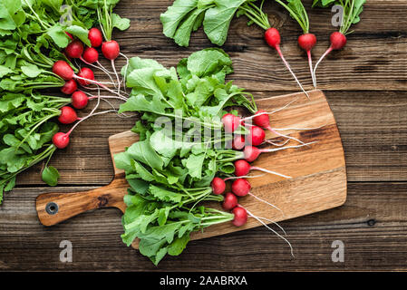 Bauernhof frische rote Radieschen aus dem Garten, frisch geernteten Radieschen auf Holzbrett Stockfoto