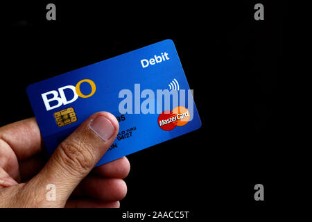 ANTIPOLO CITY, Philippinen - 20 November, 2019: Hand mit einem Soll- oder ATM-Mastercard mit EMV-Chip der BDO oder Banco de Oro. Stockfoto