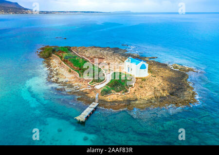 Einen alten weißen Kirche auf einer kleinen Insel bei Sonnenuntergang in Malia, Kreta, Griechenland. Stockfoto