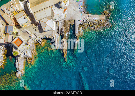 Luftaufnahme von Camogli. Schloss della Dragonara in der Nähe der ligurischen Meer Strand. Blick von oben auf den Felsen und Meer mit transparent Türkis sauberes Wasser und Stockfoto