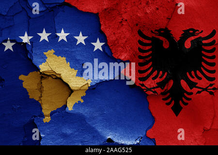 Flaggen von Kosovo und Albanien auf gerissene Wand gemalt Stockfoto