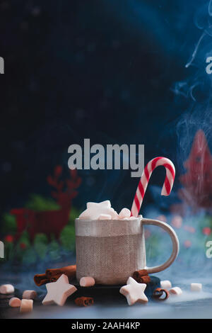 Heiße Schokolade mit sharförmigem Marshmallow, Dampf, Zuckerrohr, Winterkonzept mit Kopierraum Stockfoto