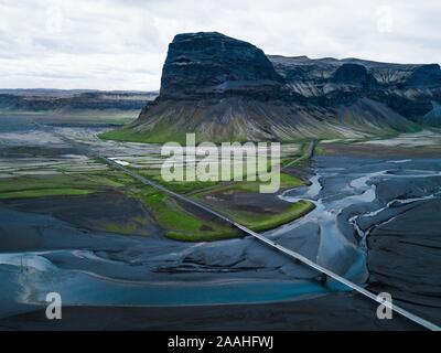 Luftaufnahme, gerade Straße durch vulkanische Landschaft, mit Flüssen und Bergen, Island Stockfoto