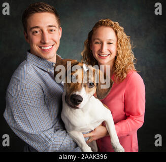 Studio Portrait von Paar mit gemischten Rasse Hund Stockfoto