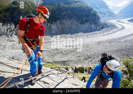 Bergsteiger steigen Leitern hinunter auf das Mer de Glace in der Nähe des Montenvers Bahnhof. Die Bahn wurde in der Viktorianischen Zeit zu nehmen Stockfoto