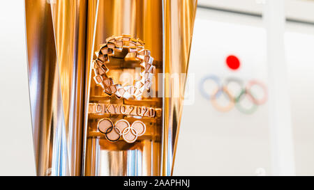 Tokio, Japan - Nov 1, 2019: Gold Trophäe Tasse Tokio Olympischen 2020 Show in Japan Olympische Museum, Olympische Spiele Logo im Hintergrund Stockfoto