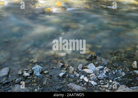 Alpine Mountain Fluss mit schönen natürlichen Felsen und Kiesel. Fotos mit langer Belichtungszeit, die Erfassung der Bewegung. Stockfoto