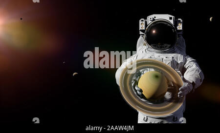 Astronaut holding Planet Saturn, Enceladus, Titan und anderen Monde Stockfoto