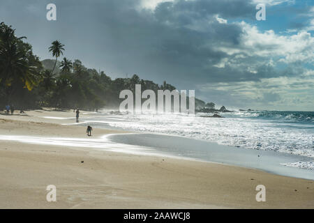 Malerische Aussicht auf Wellen plätschern am Ufer gegen bewölkter Himmel, Trinidad und Tobago, Karibik Stockfoto