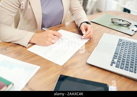 Hohen winkel Nahaufnahme der erfolgreiche Geschäftsfrau Lesen von Dokumenten während der Arbeit am Schreibtisch im Büro, kopieren Raum Stockfoto