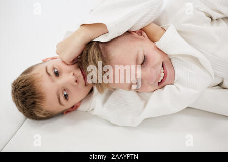 Zwei Jungen, die auf dem Boden liegen und kämpfen miteinander während der Ausbildung in Karate Stockfoto