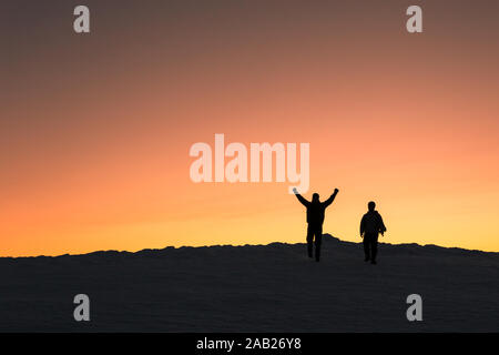 Zwei Männer steigen aus einem Winter Peak bei Sonnenuntergang Stockfoto