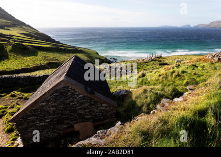Verlassene Gebäude aus Stein in der Farmer Field, Slea Head Drive mit der rauhen Atlantikküste, Halbinsel Dingle, Irland Stockfoto