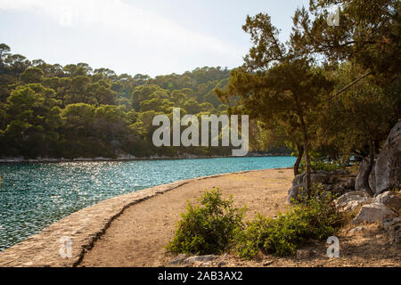 Umgebung Blick auf die kleine Insel St. Maria in Mljet, die wunderschöne Salz wasser Seen und den Nationalpark, ruhigen und friedlichen Weg mit Bäumen Stockfoto