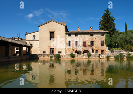 Das antike Thermalbad Dorf Bagno Vignoni und die Kirche von San Giovanni Battista in Val d'Orcia in der Toskana Italien - Bäder von St. Catherine Stockfoto