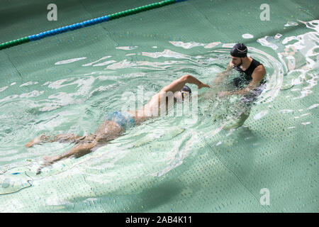 Mann, Schwimmunterricht mit einem Lehrer. Stockfoto