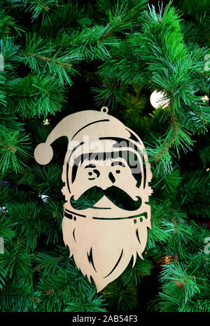 Vertikale Bild eines Holz- Santa Claus Ornament hängend an Weihnachtsbaum Stockfoto