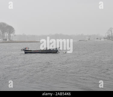 Alte Fischerdorf Arbeitsboot vertäut im Hafen bei einem Sturm. Stockfoto