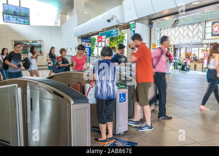 Asien/Singapur - Nov 22, 2019: Passagiere betreten und verlassen der Gantry. MRT ist eine wichtige Komponente des Systems Bahn in Singapur. Stockfoto