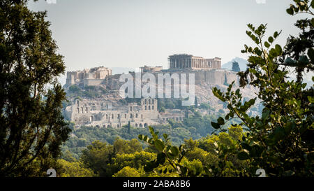 Die Akropolis und den Parthenon von Bäumen und Herodes Theater als von Filippapis Hill gesehen gerahmt Stockfoto