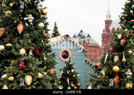 Weihnachtsbäume auf dem Roten Platz in Moskau, Neues Jahr Feier in Russland. Festliche Dekorationen auf dem Hintergrund der Kreml Tower, Magie des Urlaub Stockfoto