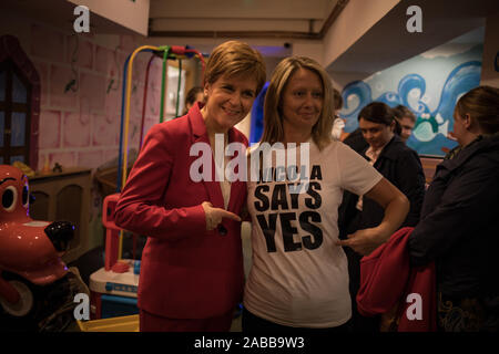 Glasgow, Schottland, 26. November 2019. Nicola Stör, Erster Minister und Leiter der Scottish National Party, auf der Campaign Trail, Met mit Kindern von einem lokalen Kindergarten und wurde von der SNP Kandidat für Lanark & Hamilton Ost, Angela Crawley, und SNP-Kandidat für Airdrie & Shotts, Neil Grau, bei Jollytots & Cookies Café in Larkhall, Glasgow verbunden. Die SNP hat Pläne angekündigt, zu "Transformieren" Elternurlaub in Schottland, Ausweitung der Gemeinsamen verlassen und 64 Wochen mit dem zusätzlichen 12 Wochen ring eingezäunt für den Vater nehmen - bis zu fördern. Quelle: Jeremy Sutton-Hibbert / alamy Leben Nachrichten. Stockfoto