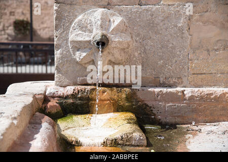 Frischem, kaltem Trinkwasser aus Brunnen auf der Piazza John Fitzgerald Kennedy im historischen Zentrum von Spello, Umbrien, Italien. August 21 2019 © wojciech Str Stockfoto