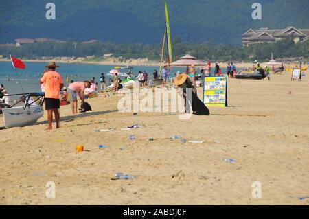 Eine Person nimmt Müll von Touristen in der Nähe der Strand von Yalong Bay Sanya city Links, South China Hainan Provinz, 4. Oktober 2019. Stockfoto